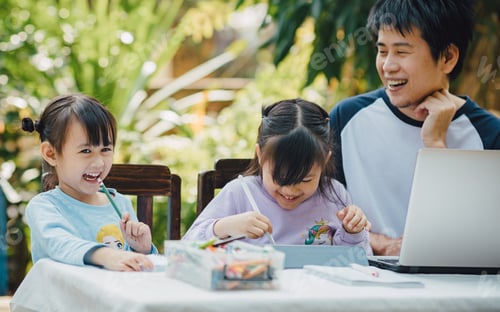 Preview: Smiling Family Together at Table with Drawing Supplies