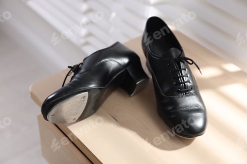 Preview: Pair of shoes for tap dance on wooden cabinet indoors, closeup