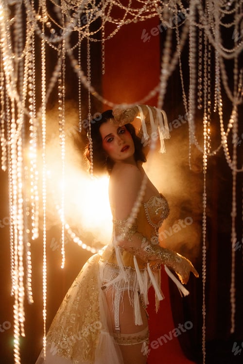 Preview: Circus-inspired retro burlesque dancer posing in golden corset with theatrical decor
