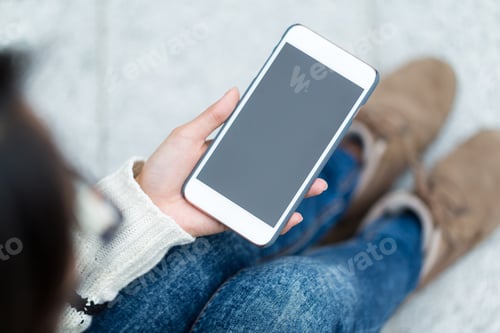Preview: Woman use of mobile phone with blank screen