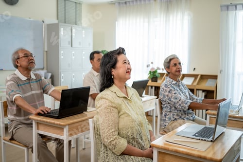 Preview: Group of Asian mature students study with instructor in class at school.