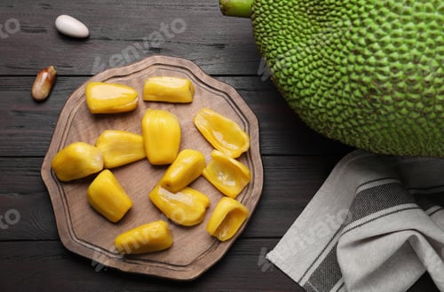 Preview: Fresh exotic jackfruit on black wooden table, flat lay