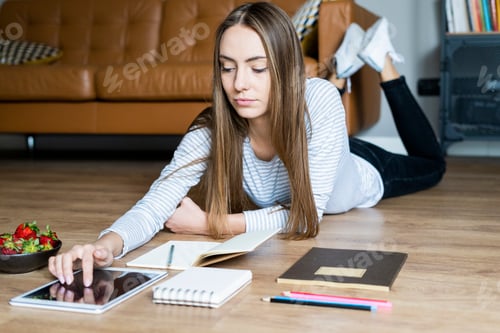 Preview: Young Woman Relaxing at Home Using Tablet