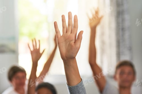 Preview: Shot of unidentifiable schoolchildren raising their hands to answer a question in class