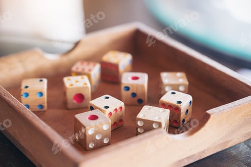 Preview: Closeup image of wooden dices in a box