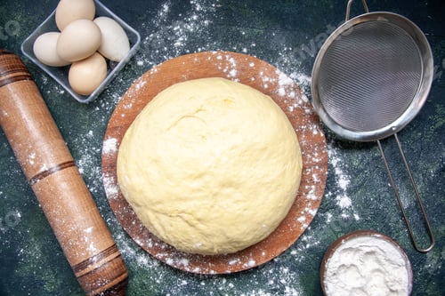 Preview: top view raw dough with white flour and eggs on the dark-blue background pastry bake cake pie raw