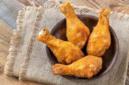 Crispy Fried Chicken Drumsticks on Wooden Table