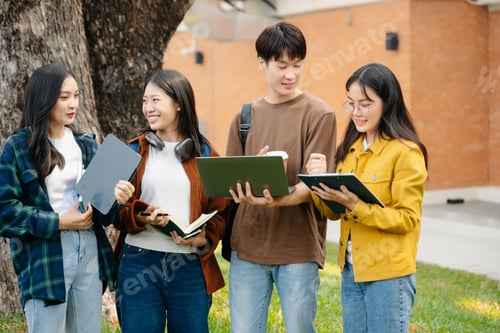 Preview: Young Asian People college students and a female student group work at the campus park in morning