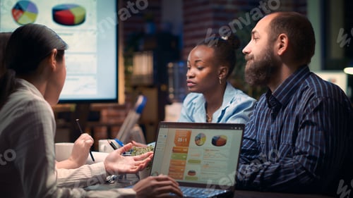 Preview: Coworkers discussing revenue statistics presentation in business meeting