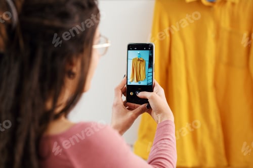 Preview: Woman taking pictures of her clothes