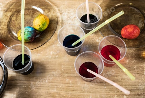 Preview: Easter eggs and colored liquid paints on the table