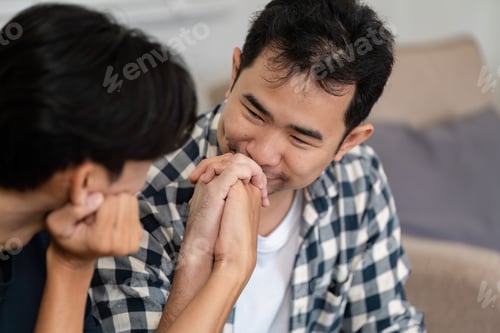 Preview: LGBTQ couple sharing a tender moment while discussing savings and financial goals in their cozy