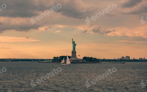 Preview: Closeup shot of the Statue of Liberty during an orange sunset
