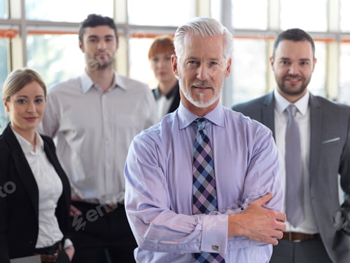 Preview: Senior Businessman With His Team At Office. Business People Group
