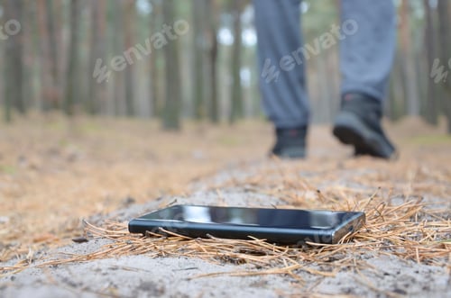 Preview: Young man loses his smartphone on Russian autumn fir wood path