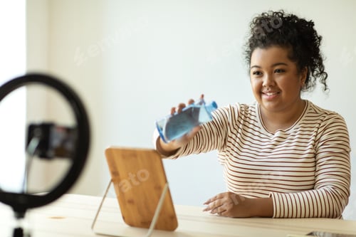 Preview: Cheerful young woman influencer recommending micellar water