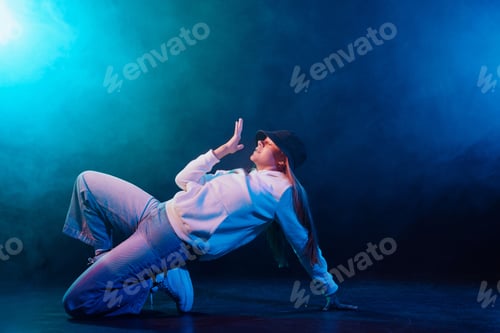 Preview: a girl in light clothes dances on a neon background in smoke, modern dance