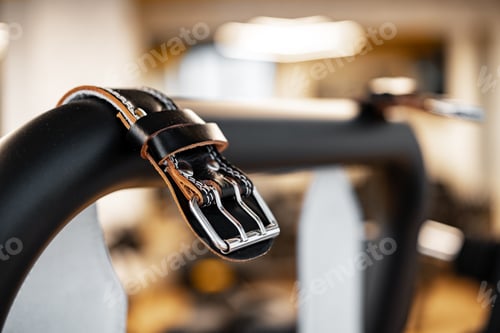 Preview: Weight belt hanging on a gym apparatus in a fitness hall