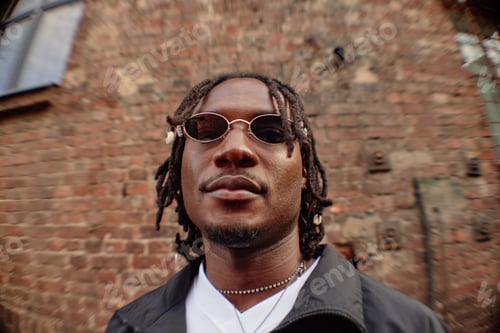 Preview: Portrait of Young Adult Black Man with Dreadlocks Wearing Sunglasses Smiling
