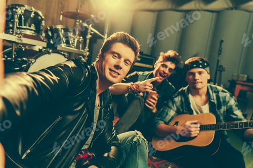 Preview: selective focus of happy man taking selfie with cheerful friends