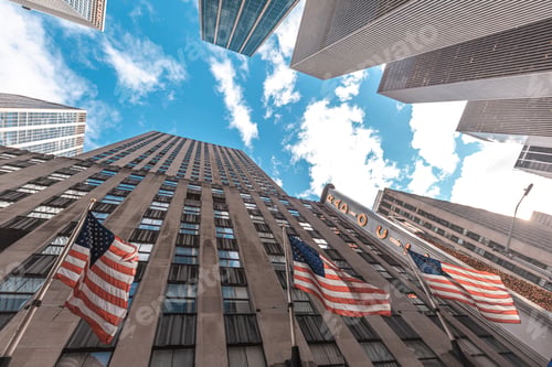 Preview: Skyscrapers in Manhattan with American flags and sky above