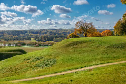 Preview: A path winding through Kernave archaeological site under cloudy autumn sky in Lithuania