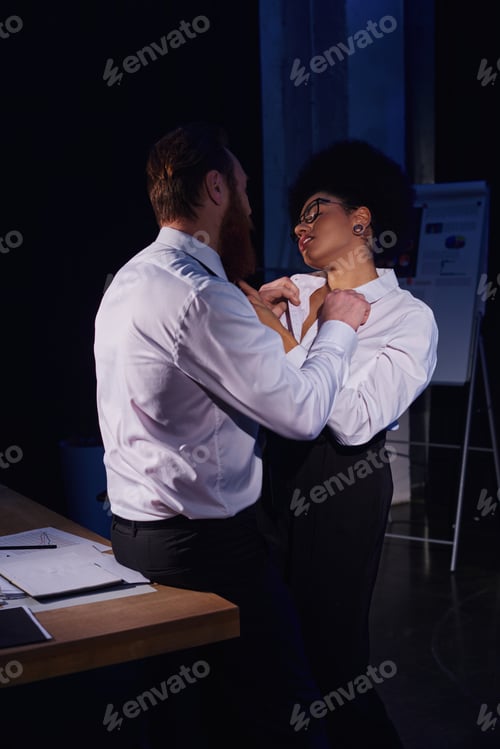 Preview: businessman undressing hot and charming african american woman in eyeglasses in office, work romance
