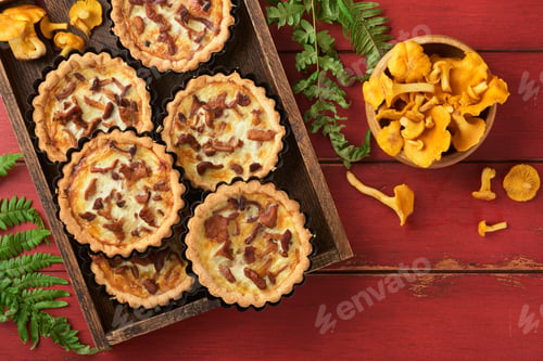 Preview: Savory hands pie with chanterelle mushrooms, cream and cheese on cutting board on rustic old red woo