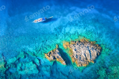 Preview: Aerial view of beautiful yacht on the sea and rocks at sunset