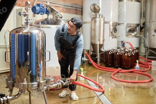 Preview: Cider Factory Worker Operating Boiler Machine while Pasteurizing Juice Indoors
