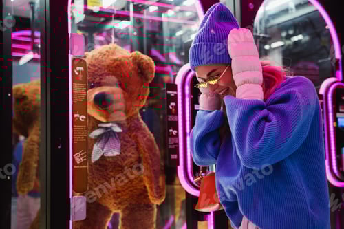 Preview: Cheerful stylish woman wearing sunglasses shaped like fire flames, is having fun in a snowy winter a