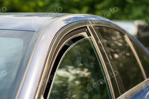 Preview: Closeup of slightly ajar car window for better cooling on hot summer day. Heat, high temperature