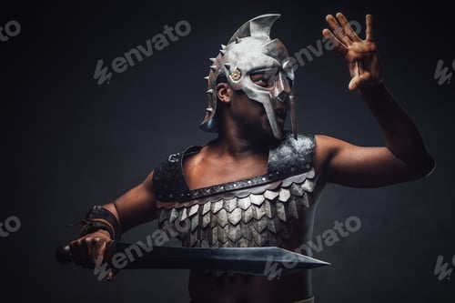 Preview: Proud antique gladiator with sword against dark background