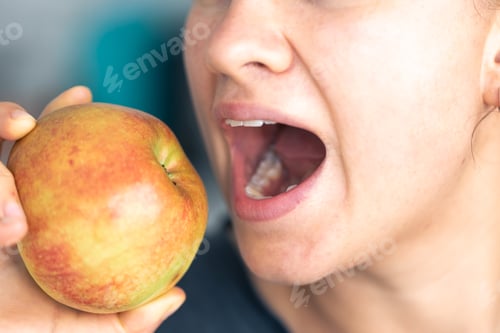 Preview: Detailed shot of a woman eats whole fresh apple.
