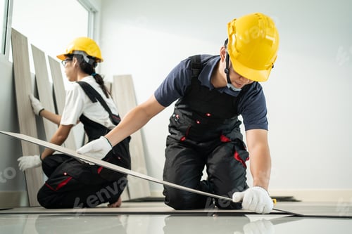 Preview: Asian Craftsman worker people installs laminate board on floor at home.