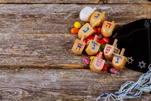 Preview: Image of jewish holiday Hanukkah with wooden dreidel spinning top on the glitter background