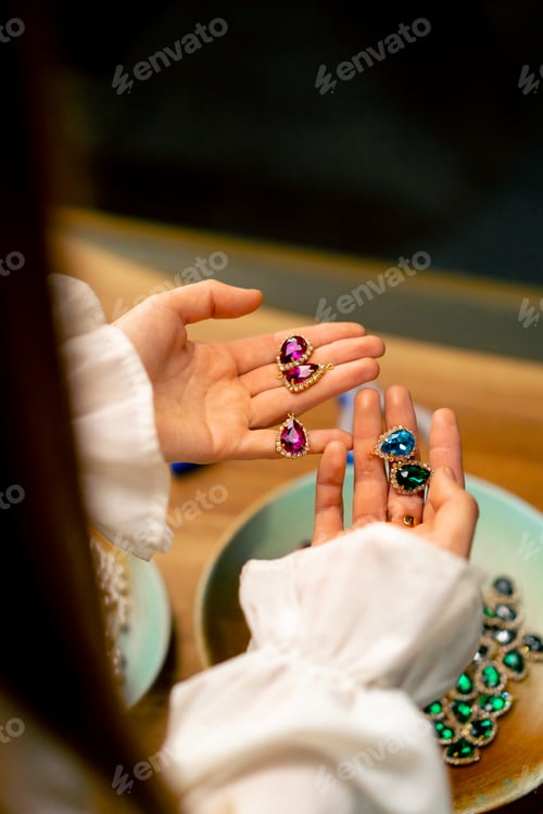 Preview: female hands holding multi-colored stones and pendants for necklace craft jewelry making home beauty