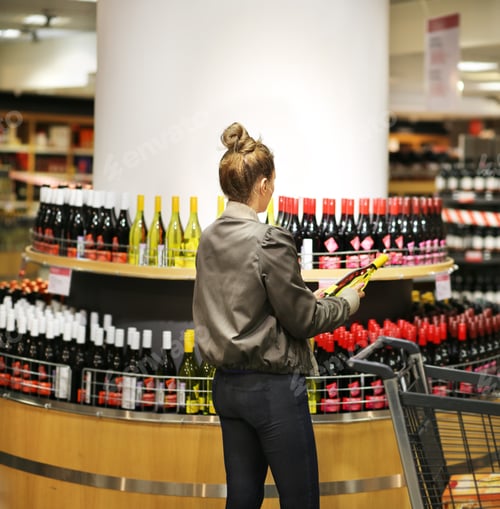 Preview: Woman Choosing A Wine, Champagne At Supermarket
