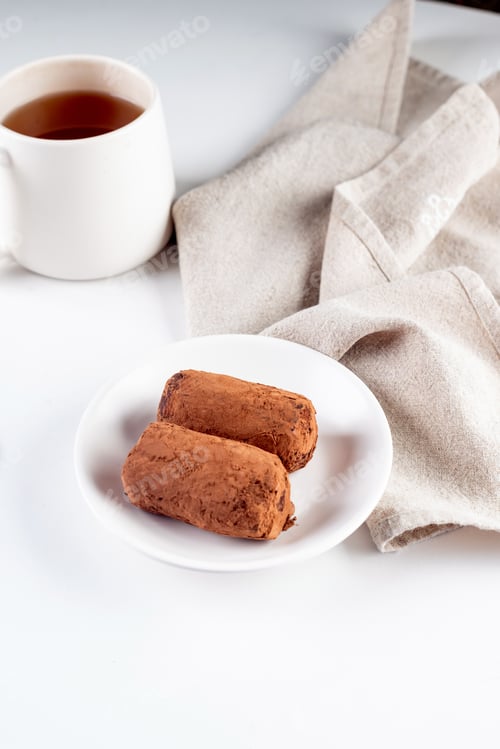 Preview: Chocolate Cake. biscuit with cream cocoa powder on plate. Truffle dessert, sprinkled cocoa powder,