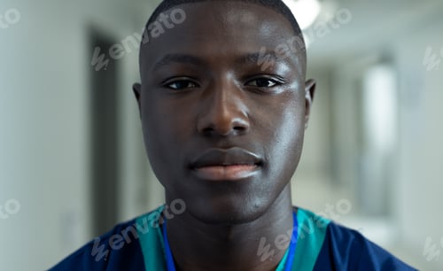 Preview: Portrait of african american male healthcare worker in hospital corridor, copy space