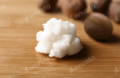 Preview: Fresh shea butter on wooden table, closeup. Cosmetic product