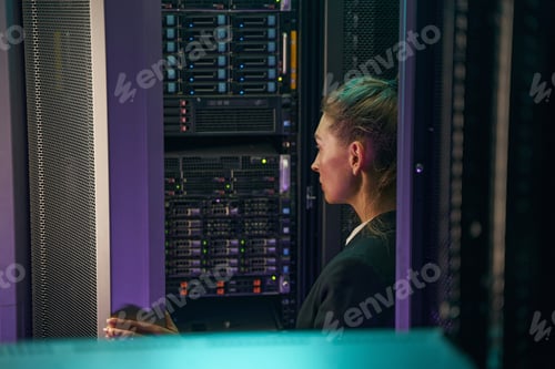 Preview: Professional young woman working in server room