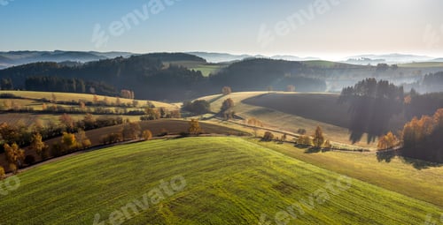 Preview: High angle shot of a beautiful green landscape with a lot of trees under the bright sky