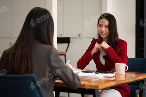 Preview: Young Asian businesswoman work together to analysis from work at the office