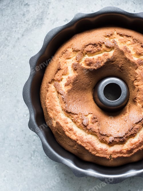 Preview: Close up of pound cake in a baking form, overhead view