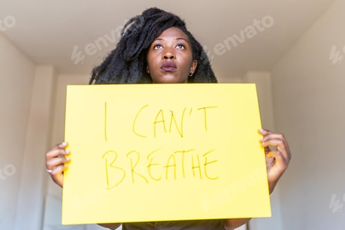 Preview: Young black woman holding "I can't breath" banner indoor