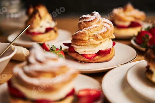 Preview: Delicious cream puff with strawberries and chocolate on a wooden table with a black background