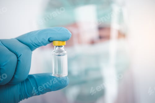 Preview: doctor or scientist holds a liquid vaccine bottle for the treatment of viral diseases.