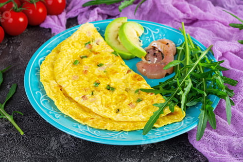 Preview: Fried omelette with ham, onion and herbs. Breakfast with scrambled eggs