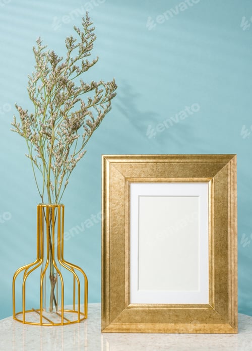Preview: blank luxury gold photo frame with flower vase decor on stone table wtih blue background